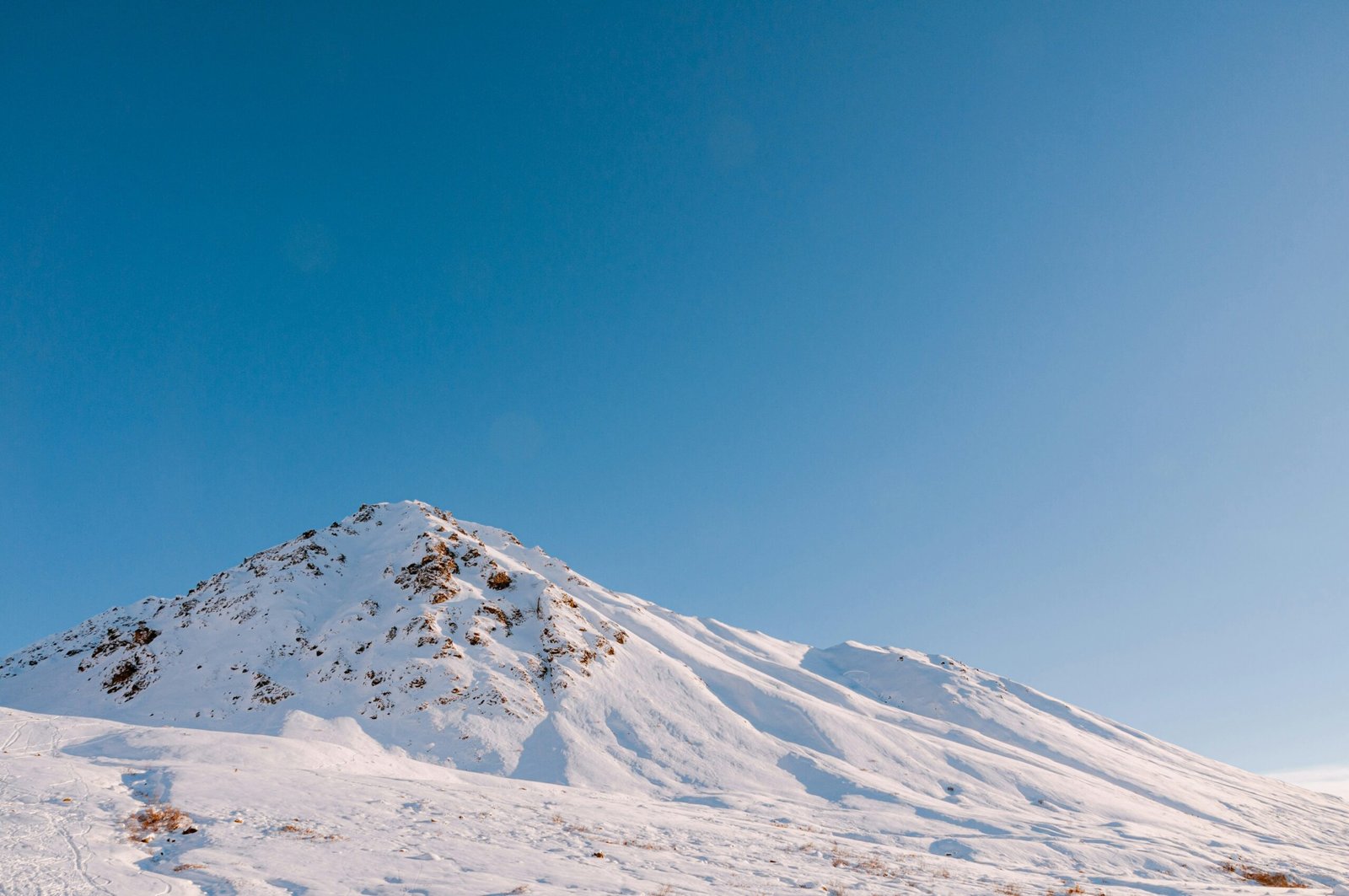 snow covered mountain under blue sky during daytime